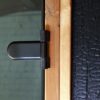 Black Barrel sauna close up of 8mm tempered glass door and Ignite Spruce timber