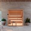 The Nativa Alder Indoor Sauna next to pot plants.