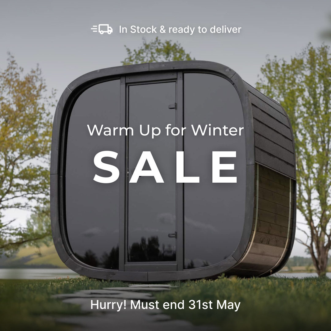 Modern curved black cabin on a grassy field with the word SALE and the headline 'Warm Up for Winter' in white text; 'Hurry! Must end 31st May' below.