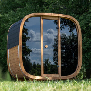 The Dice Indoor and Outdoor Sauna set up on the grass.