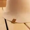 Close up of a beige bell shaped sauna hat in a sauna.