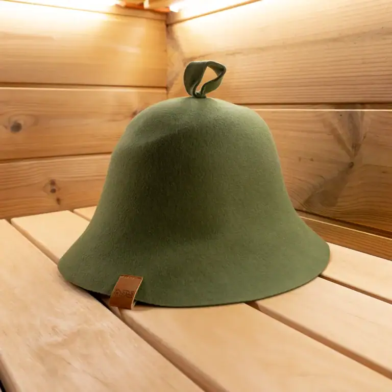Green Sauna Hat on a sauna bench.