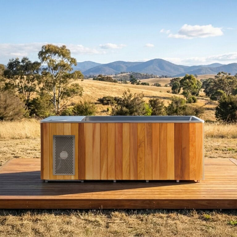 Red cedar ice bath outside, with hills behind it.