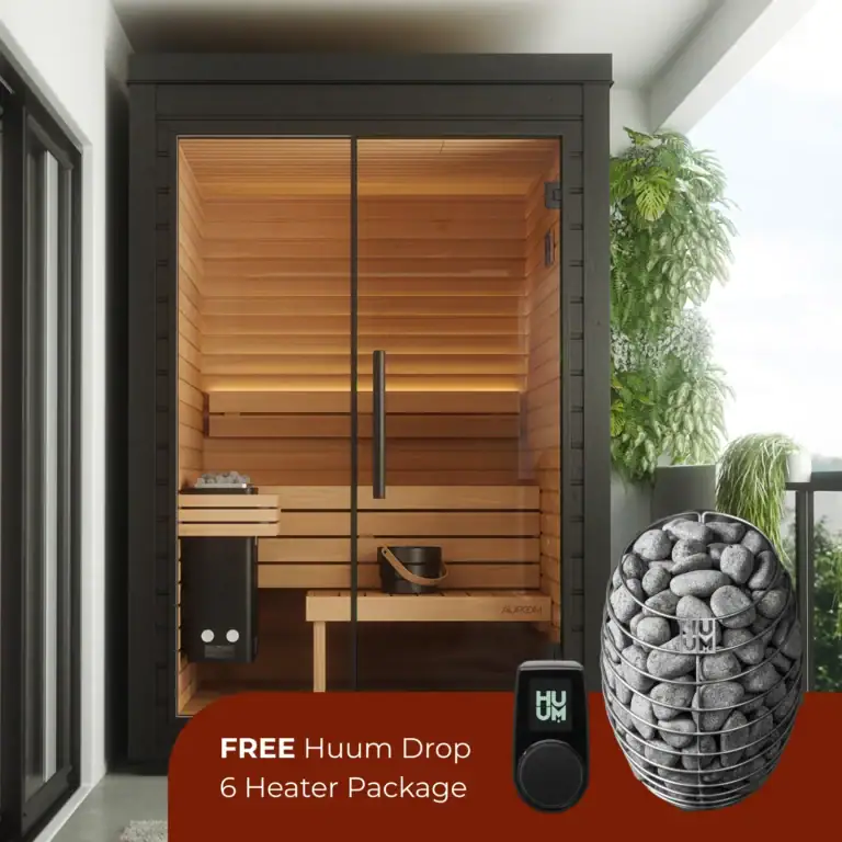 Outdoor sauna with glass door and warm wooden interior; bottom promo text says 'FREE Huum Drop 6 Heater Package'