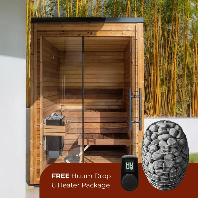 Outdoor wooden sauna with a glass door, set against a bamboo backdrop; promotional text for a Free Huum Drop 6 Heater Package with a heater stone image.