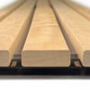 Close-up of light-brown wooden boards stacked on a pallet.
