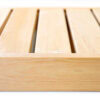 Close-up of light wood slats with narrow gaps, forming a wooden surface.
