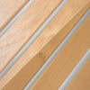 Diagonal wooden floorboards with silver metal strips running between them