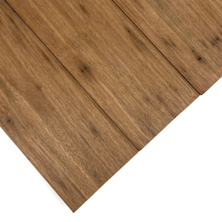 Close-up of brown wood planks with visible grain running diagonally and curved edges.