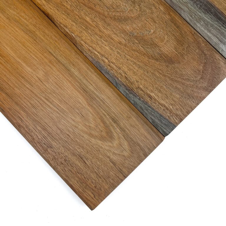 Close-up of brown wood floor planks with visible grain and a dark border plank running diagonally across the image.