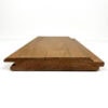A single brown wooden floor plank with a tongue-and-groove edge, viewed from a low angle against a white background.