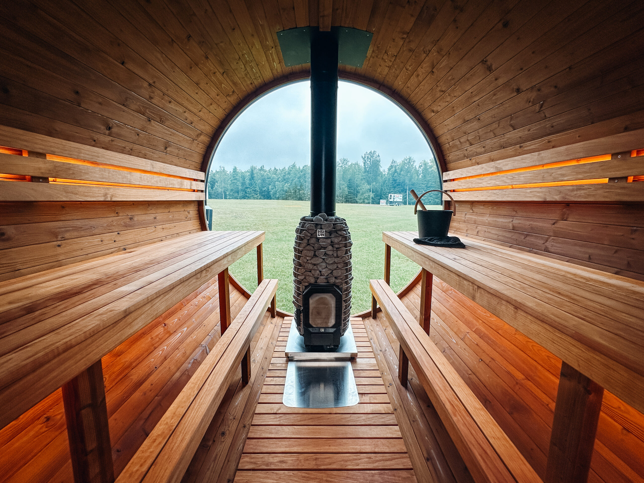 Inside an Auroom Barrel Sauna with high benches.