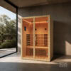 Wooden indoor sauna with glass doors, warm interior lighting, and two-tier benches in a modern room