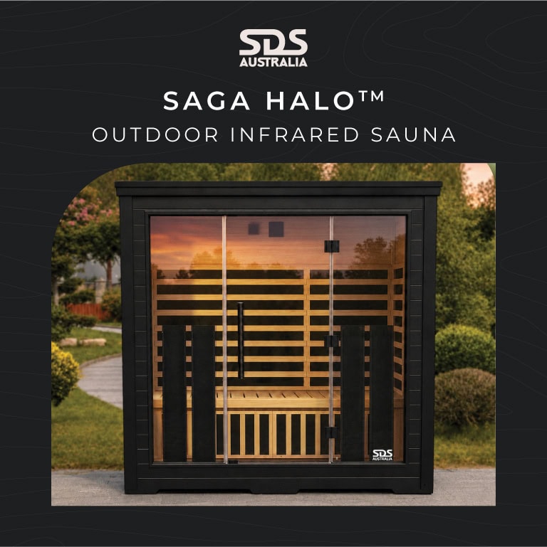 Saga Halo outdoor infrared sauna by SDS Australia, a black cabinet with a glass door in a garden setting.